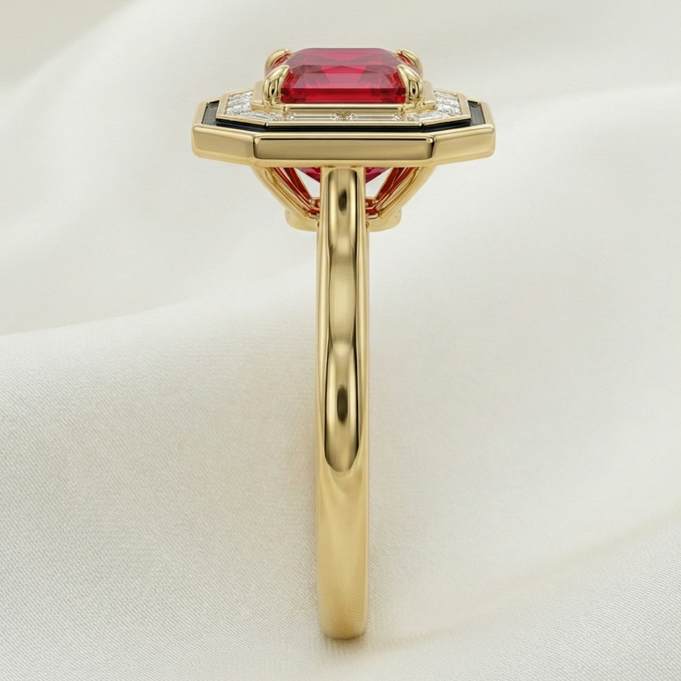 Gold ring with a red radiant cut diamond on a white background