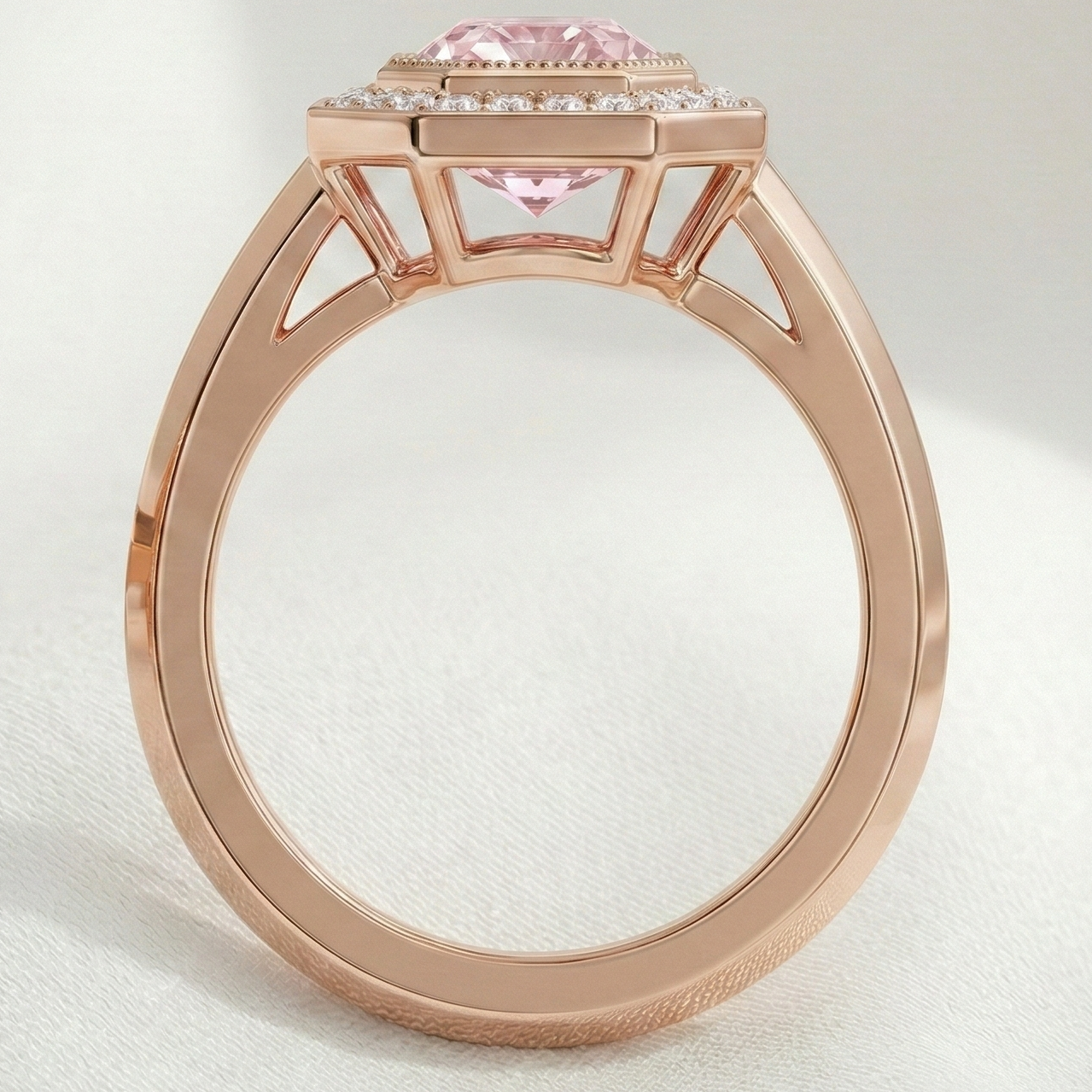 Rose gold ring with a pink gemstone on a light gray background